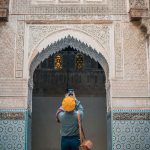 An-Asian-Chinese-female-tourist-photographing-and-admiring-Fez-Mosque-Bou-Inania-Madressa