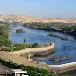 An aerial view of the Aswan High Dam and its immense reservoir, Lake Nasser, showcasing a modern engineering marvel in Egypt.