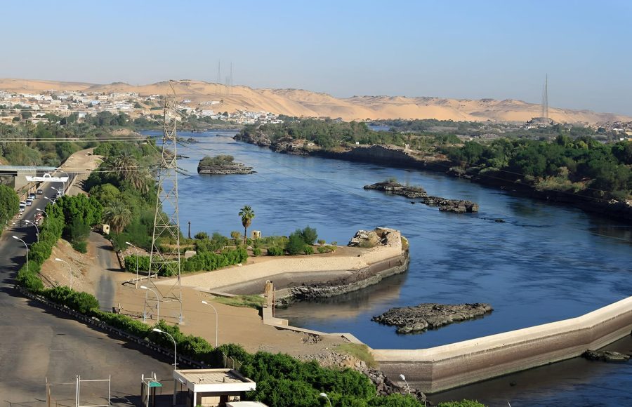 An aerial view of the Aswan High Dam and its immense reservoir, Lake Nasser, showcasing a modern engineering marvel in Egypt.