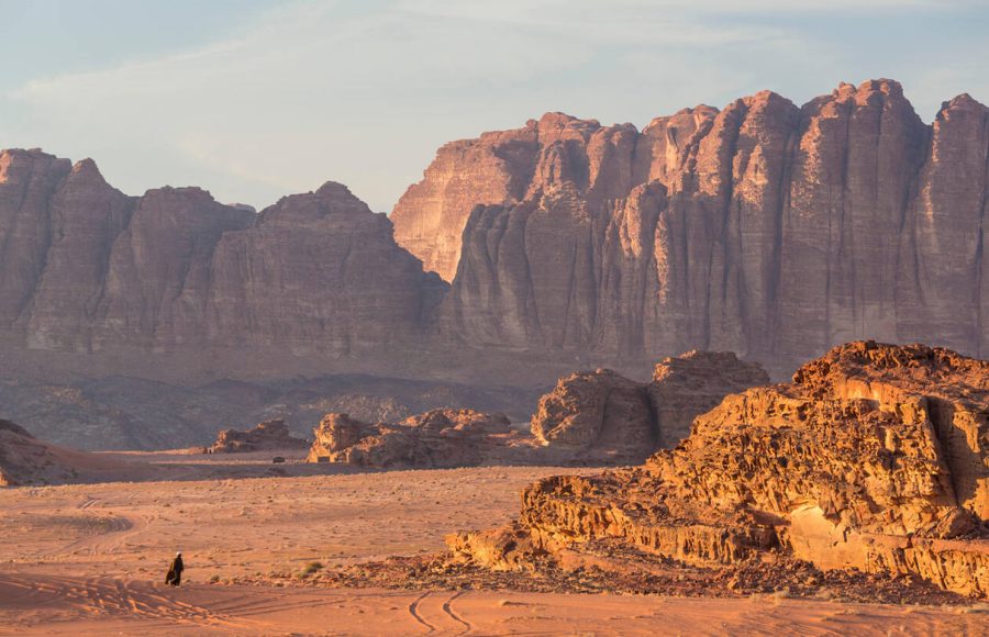 Bedouin-man-walking-across-desert-Wadi-Rum-Jordan
