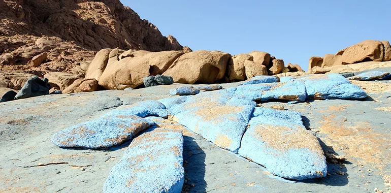 Blue-Painted Rocks Scattered On The Ground In The Sinai Peninsula's &Quot;Blue Desert&Quot; Landscape.