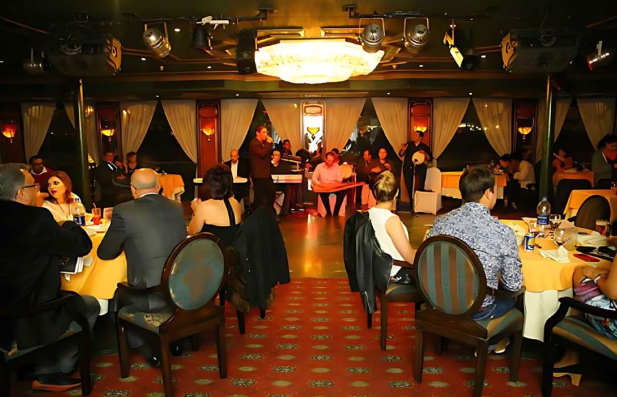 A live band performing traditional music for guests on a Nile cruise with a belly dancer and folk music