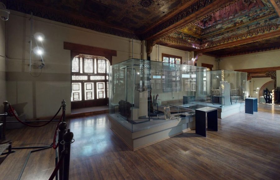 Inside the beautiful museum hall, a highlight of any Cairo highlights tour, showcasing artifacts in glass cases and historic architecture.