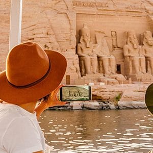 Mother and son enjoying a boat tour view of Abu Simbel Temple.