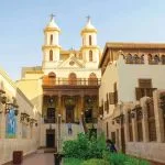 The historic Hanging Church stands beautifully under a clear blue sky during a professional Cairo museum and Old Cairo excursion