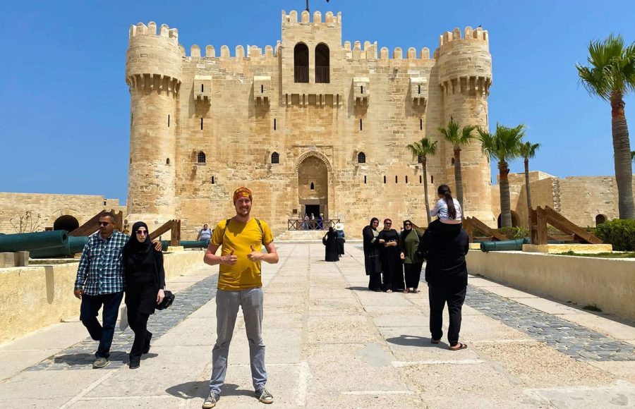 Tourists posing outside the majestic Qaitbay Citadel on a popular Cairo to Alexandria day trip