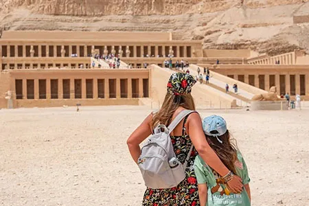 Mother and daughter visit Hatshepsut Temple during a Luxor day tour by plane