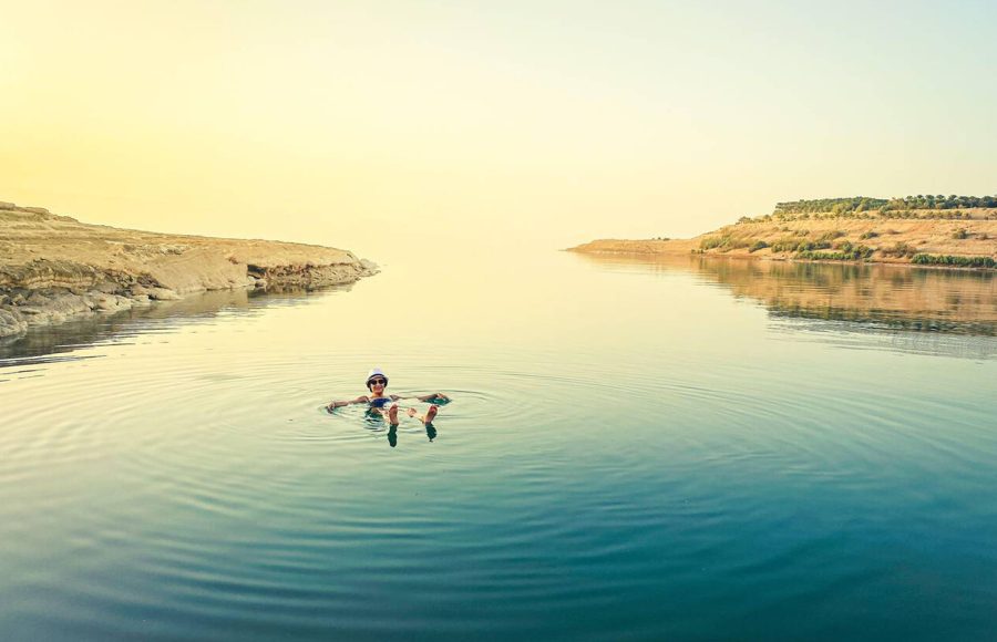 Caucasian-female-tourist-float-on-dead-sea-water-happy-enjoy-vacation-in-Jordan