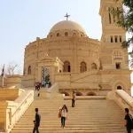 Tourists walk up the steps of the Church of St George during a Coptic Cairo tour