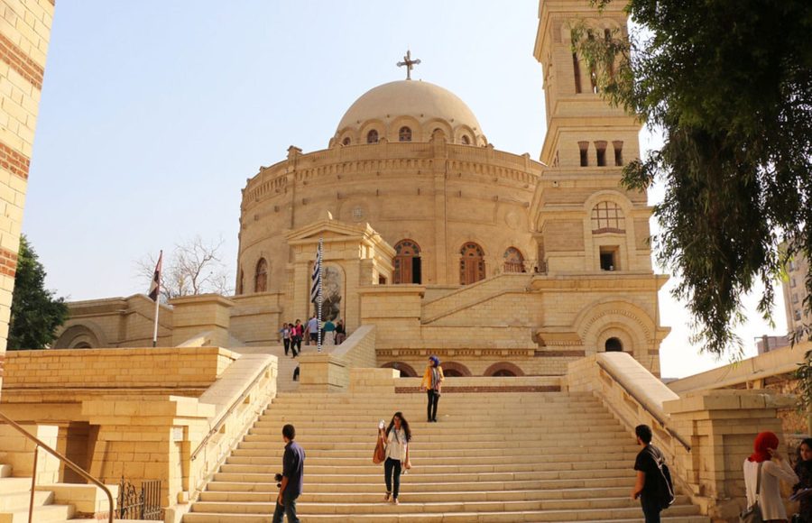 Tourists walk up the steps of the Church of St George during a Coptic Cairo tour