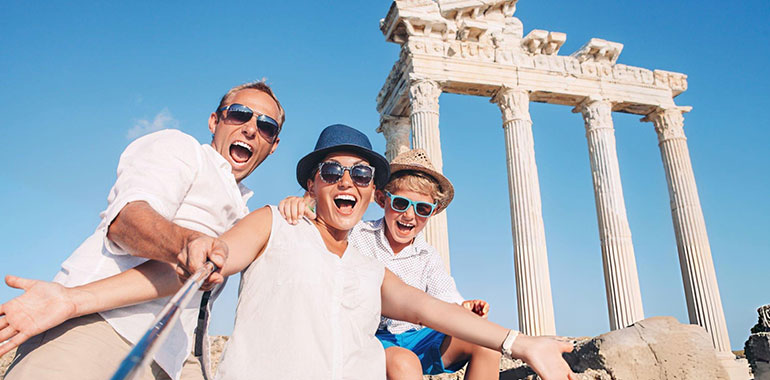 Crazy happy family selfie travel photo on the antique colonnade background at the Temple of Apollo Turkey