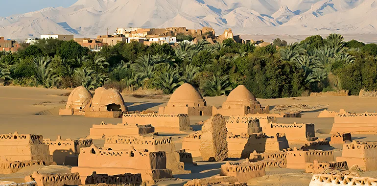 Panoramic View Of The Historic Town Of Al-Qasr At Dakhla Oasis, Featuring Palm Trees And Ancient Buildings, Ideal For Egypt Oasis Tours.