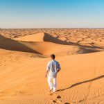 Dubai-desert-sand-dunes-young-men-walking-at-the-sand-dunes-of-Dubai-during-a-desert-safari