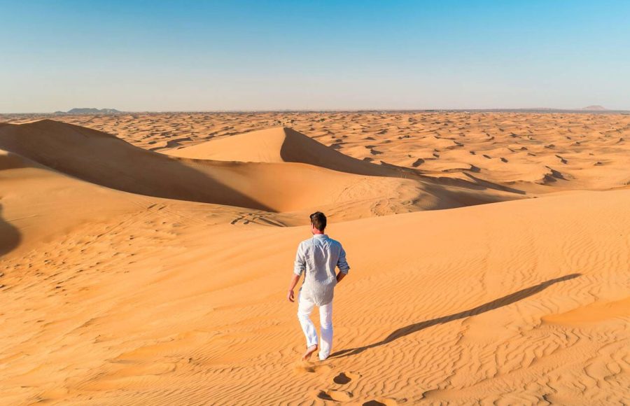 Dubai-desert-sand-dunes-young-men-walking-at-the-sand-dunes-of-Dubai-during-a-desert-safari
