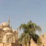 The imposing exterior of Egypt Cairo The Citadel of Salah El Din and Alabaster Mosque of Mohamed Ali against a clear sky, showing the multiple domes and towering minarets of the mosque.