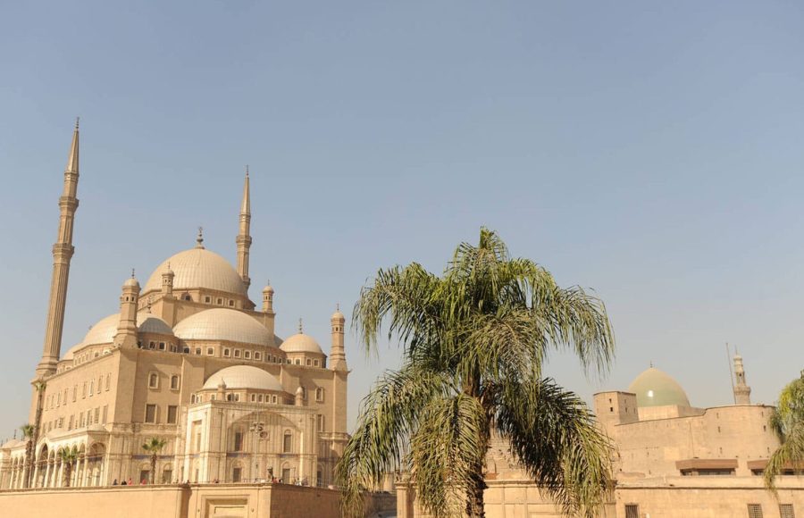 The imposing exterior of Egypt Cairo The Citadel of Salah El Din and Alabaster Mosque of Mohamed Ali against a clear sky, showing the multiple domes and towering minarets of the mosque.