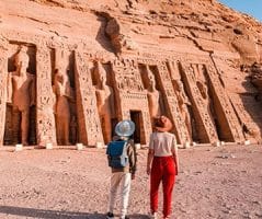 Two travelers gaze upon the magnificent temples of Abu Simbel including the Temple of Queen Nefertari on their Egypt holiday packages from Malaysia