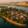Hor Diab Island in the Nile, showing a cluster of mud-brick houses surrounded by palm trees.