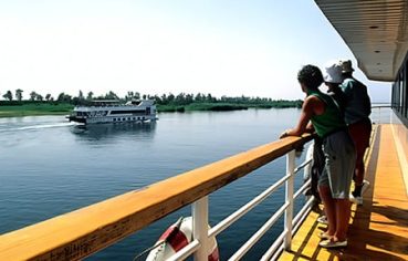 Two travelers stand on the deck of a cruise ship, an essential part of the 10 Day Nile Cruise and Cairo Itinerary.