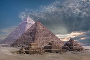 The Pyramids of Giza under a dramatic sky, a key historical site included in Egypt packages from Kolkata.