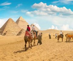 Explore the Giza Pyramids with Egypt Tour Packages From Muscat Experience the iconic wonders on Egypt tour packages from Muscat, including an unforgettable camel ride through the desert with the majestic pyramids in the background.