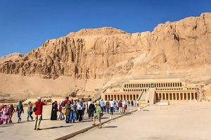 Tourists explore the Temple of Hatshepsut, a highlight in Egypt Travel Packages From Pakistan. Tourists visiting the Temple of Hatshepsut, a key attraction in Egypt classic vacation packages from Pakistan.