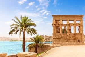Philae Temple Tours From Oman to Egypt Explore scenic Egypt tours from Oman and discover the ancient Philea temple surrounded by tranquil waters and palm trees.