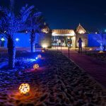 Exterior-view-of-an-illuminated-desert-safari-camp-and-resort-in-the-Sharjah-Dubai-desert-United-Arab-Emirates