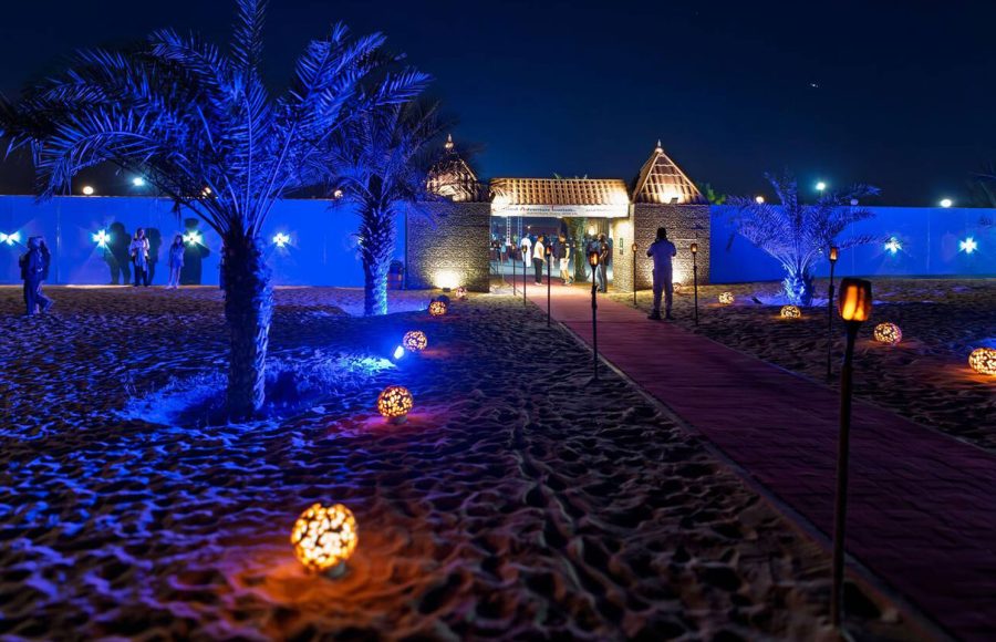 Exterior-view-of-an-illuminated-desert-safari-camp-and-resort-in-the-Sharjah-Dubai-desert-United-Arab-Emirates