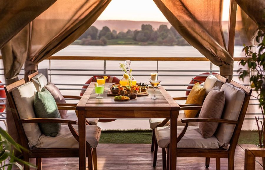 MS Farah Nile cruise ship sailing on the river under a clear blue sky.