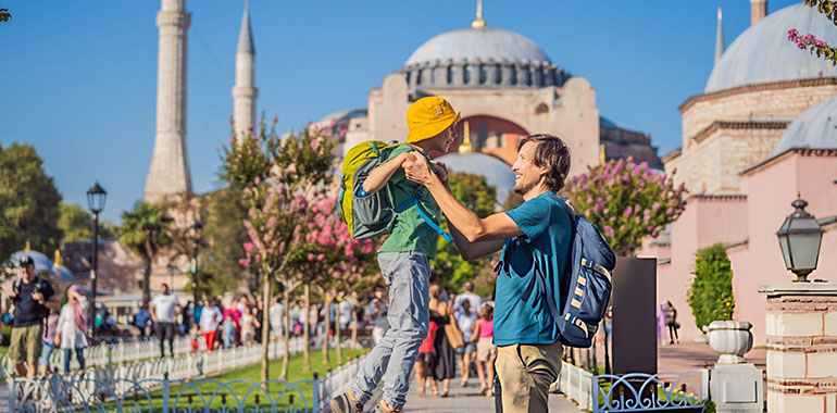 Father and son Tourists enjoy beautiful view on Hagia Sophia Cathedral famous islamic Landmark mosque