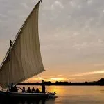 A group sails into the sunset ahead of their scheduled Nile cruise with a traditional music