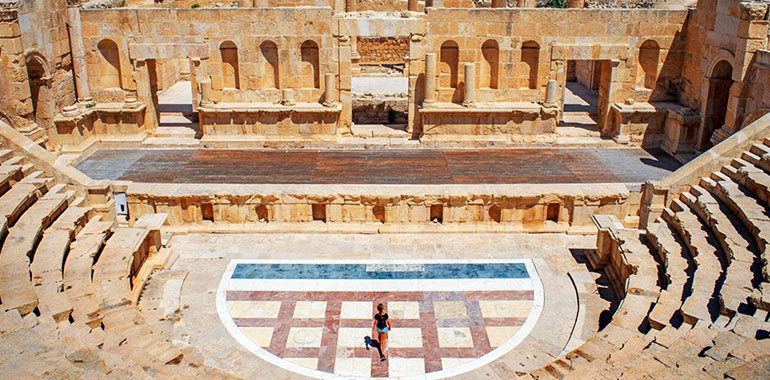 Female Tourist Walking Through The Roman Theatre Amman Jordan