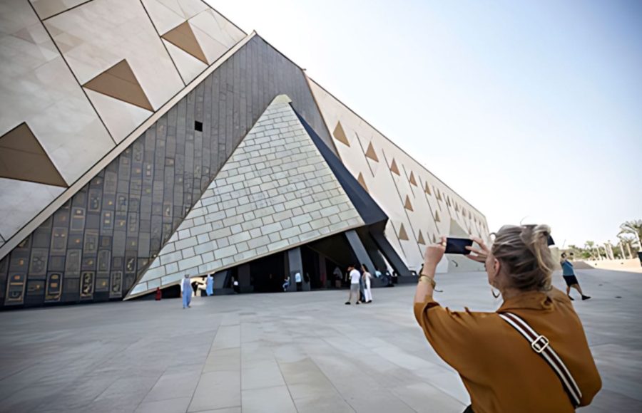 A visitor captures a photo of the stunning triangular architecture during a GEM private tour