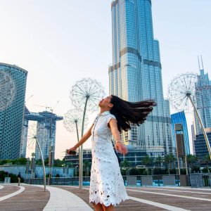 Girl having a walk in front of Dubai mall fountain at day time