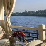 Wicker armchair on a boat deck overlooking the Nile.
