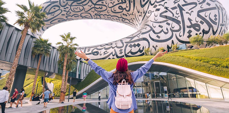 Happy Tourist Girl Admire View Of The Famous Future Museum In Shape Of Crescent With Arabic Inscriptions And Pond