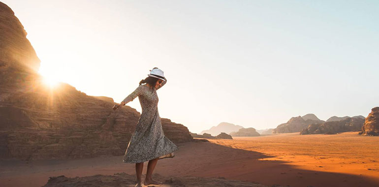 Happy Joyful Woman Tourist Stand And Dance On Cliff Barefoot At Viewpoint And Enjoy Holiday Vacation In Wadi Rum Panorama On Sunrise 1