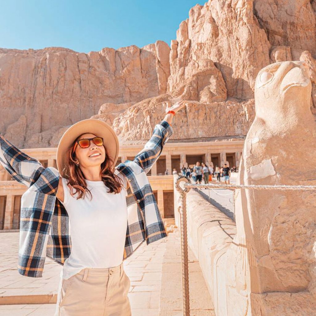 Happy Woman Explores The Ruins Of The Ancient Egyptian Hatshepsut Temple In The Heritage City Of Luxor