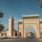 Historic-Triumphal-Arch-in-Rissani-Morocco-Surrounded-by-Palm-Trees-on-a-Sunny-Day