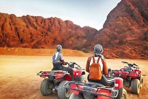 Enjoy thrilling desert adventures on quad bikes with exciting holiday packages to Egypt from Sri Lanka, set against stunning mountains.