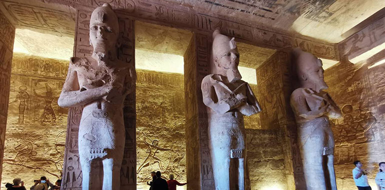 Inside the Temple of Abu Simbel. View of the hypostyle hall featuring eight colossal pillars statues of Ramesses II