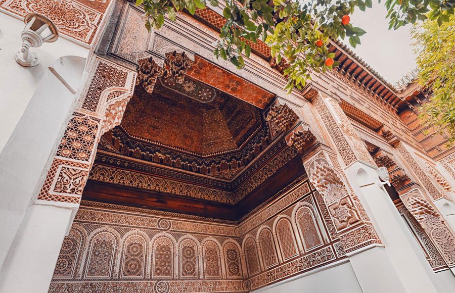 Intricate-carvings-and-geometric-patterns-adorn-the-walls-and-ceiling-of-Bahia-Palace-showcasing-traditional-Moroccan-artistry