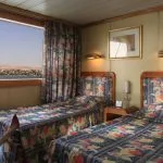 Twin cabin on the Jaz Amara Nile Cruise with a view of the river.