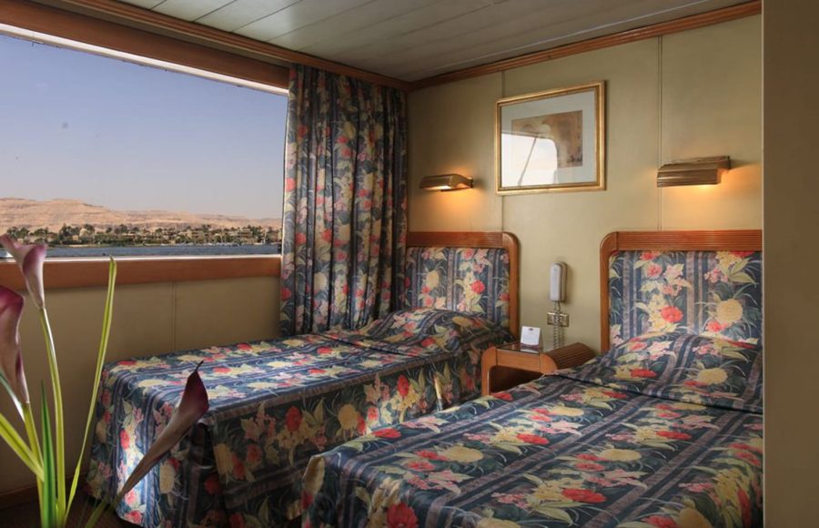 Twin cabin on the Jaz Amara Nile Cruise with a view of the river.