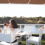 Woman taking a photo from the sun deck of the Jaz Imperial Nile Cruise.