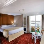 The spacious main cabin on the La Traviata Nile Cruise offers comfort and a scenic balcony view.