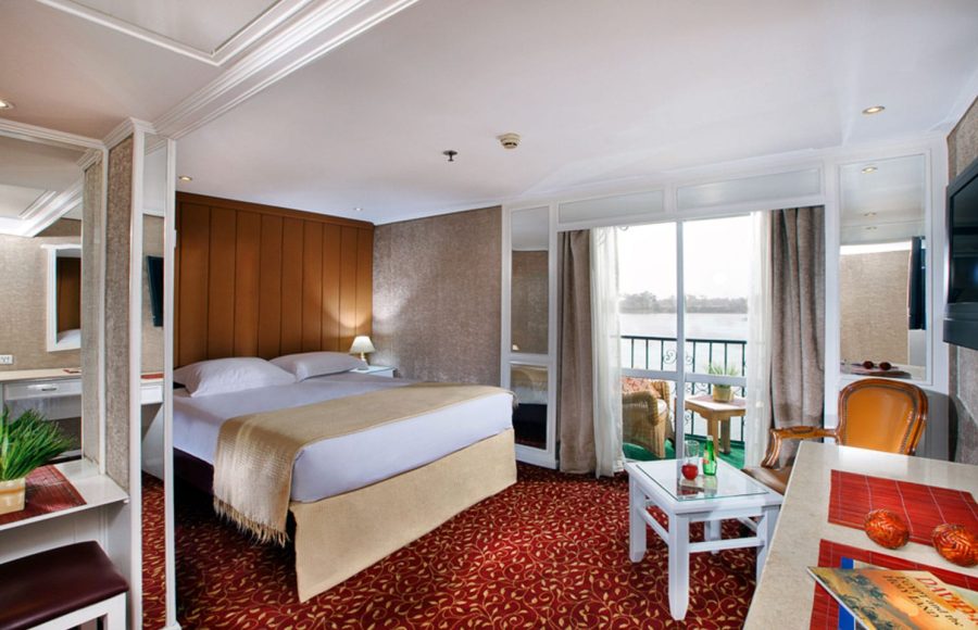The spacious main cabin on the La Traviata Nile Cruise offers comfort and a scenic balcony view.