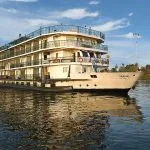 A beautiful exterior view of the multi-deck La Traviata Nile Cruise sailing on the river.