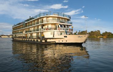 A beautiful exterior view of the multi-deck La Traviata Nile Cruise sailing on the river.
